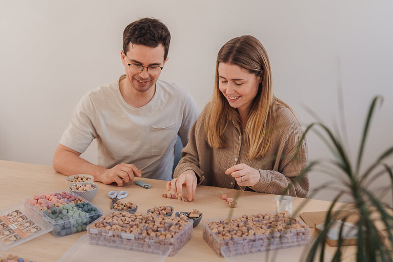 Mann und Frau am Basteltisch von Schnullerketten